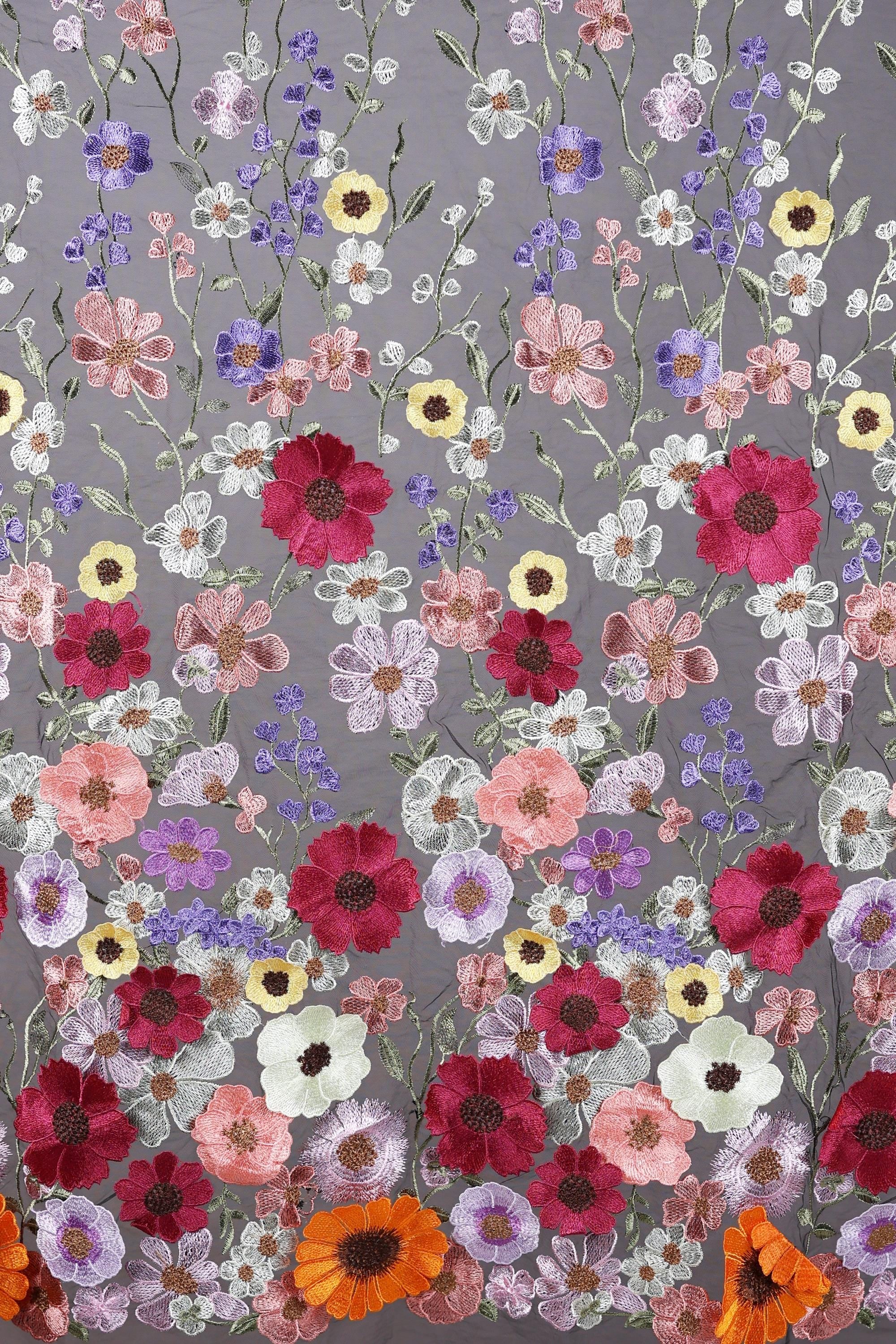 a vibrant and colorful floral pattern with a variety of flowers in shades of red, pink, white, and purple. The flowers are intricately embroidered and arranged in a visually appealing manner, creating a lively and dynamic composition.