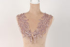 A mannequin wearing a pink sequin and lace neckline.