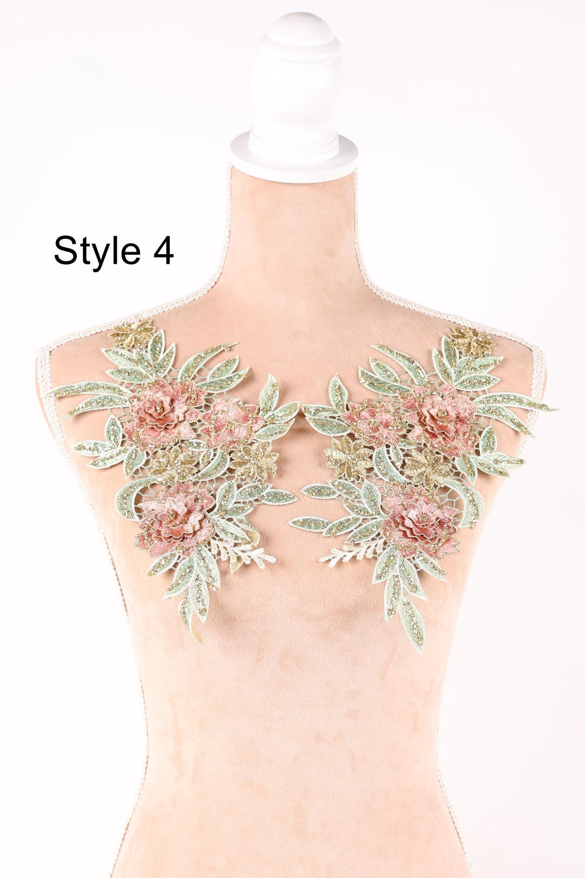 A mannequin with a floral design on its bust, featuring pink and green flowers and leaves.
