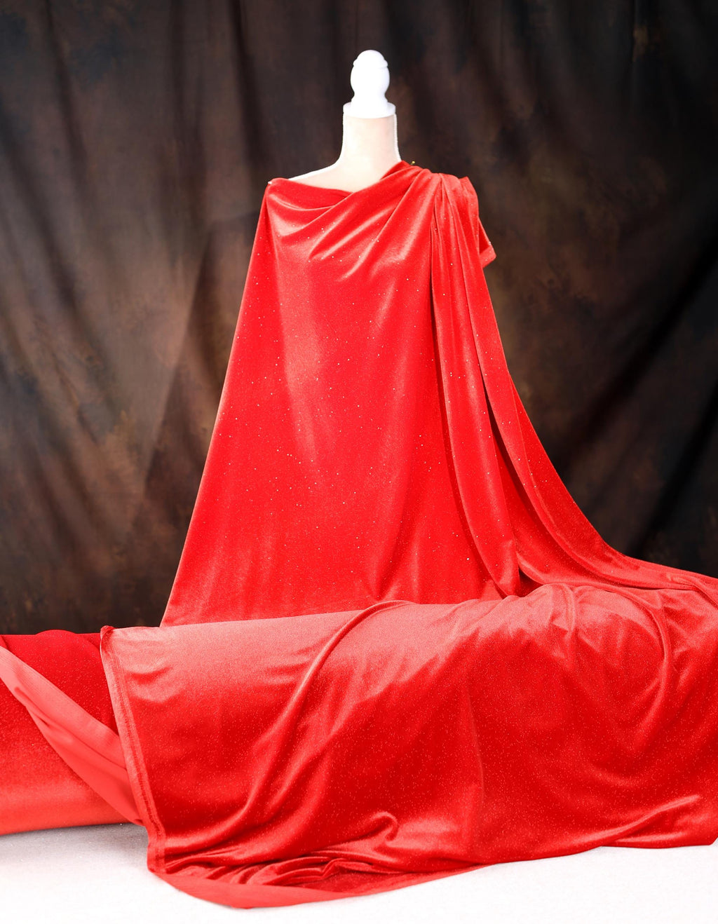 a mannequin dressed in a red cape