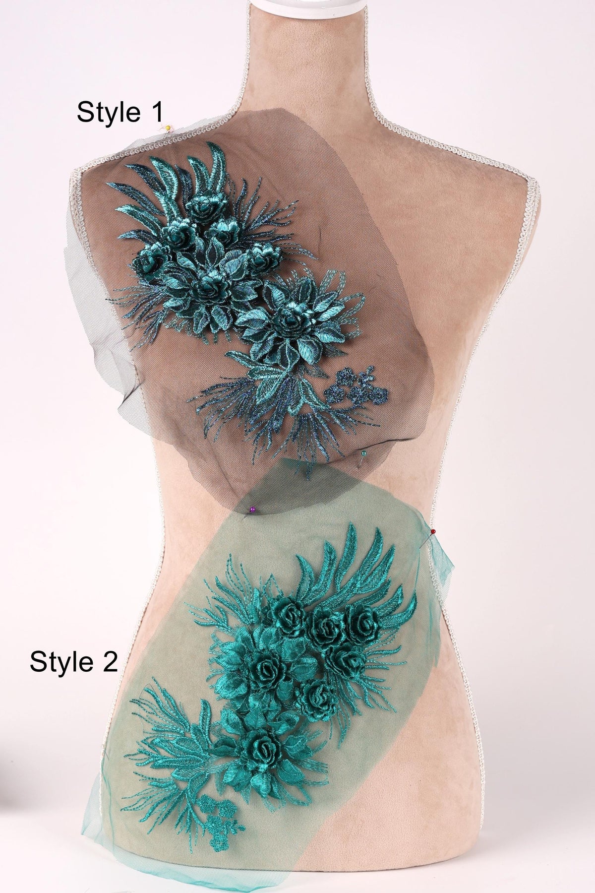 A mannequin with two different styles of floral embroidery on its torso. The first style features a dark green floral design, while the second style has a lighter green floral design.