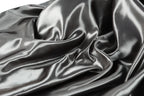 a close-up view of a shiny, silky fabric with a smooth, shiny texture.