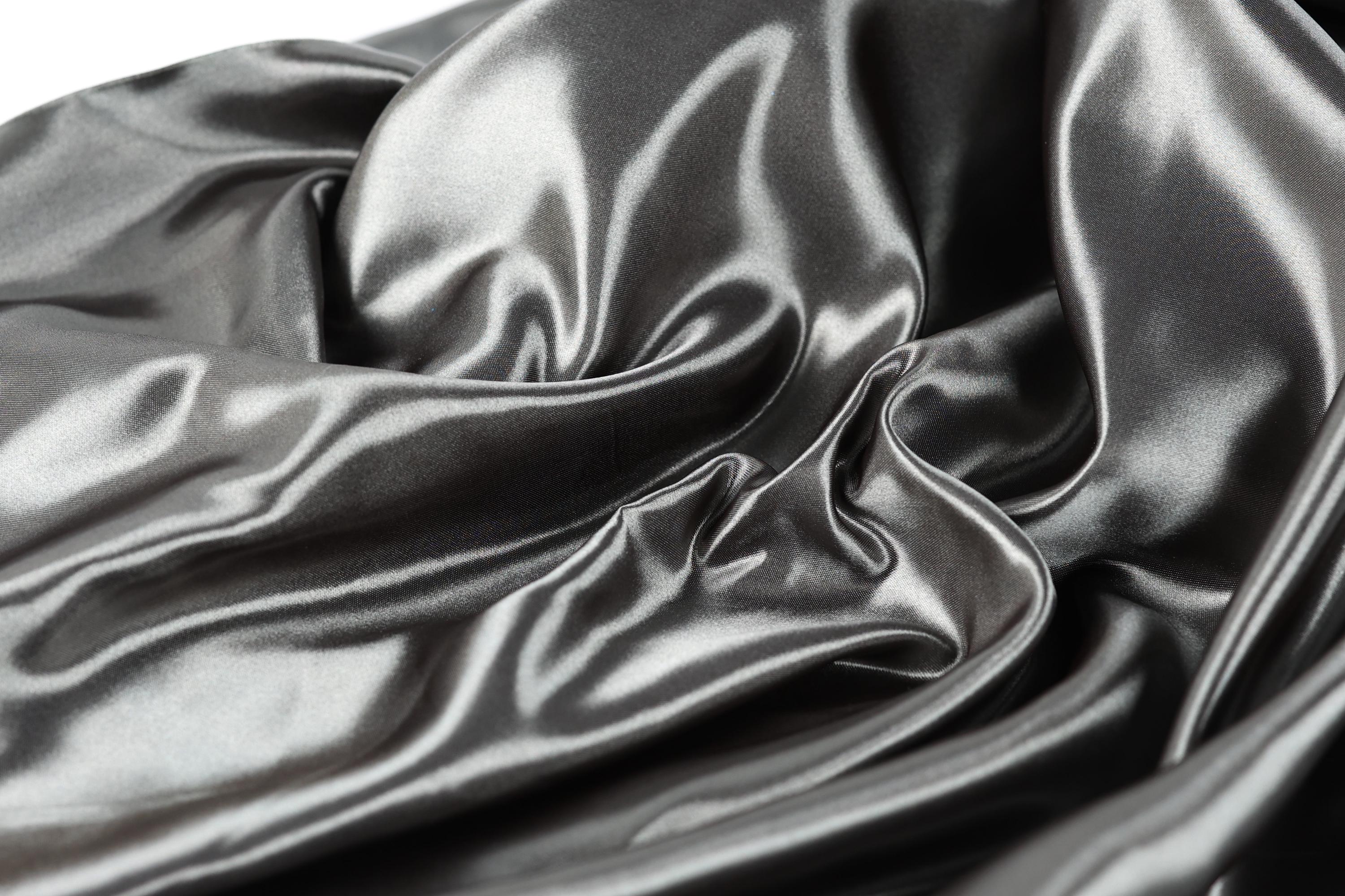 a close-up view of a shiny, silky fabric with a smooth, shiny texture.