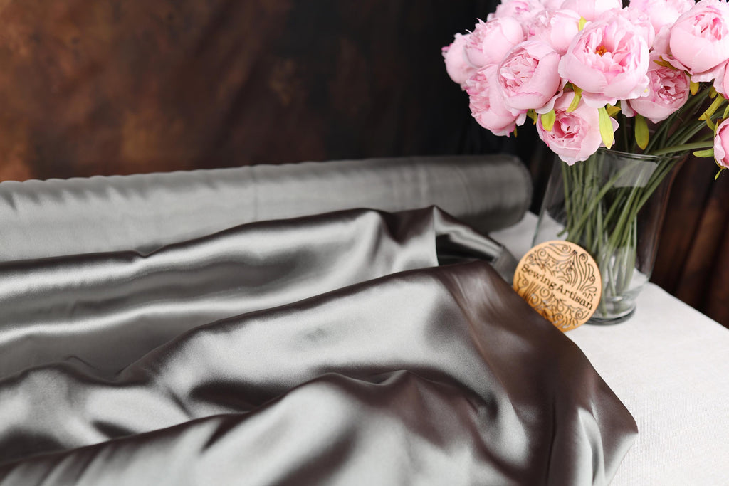 a vase filled with pink flowers on top of a table