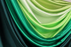 a close-up view of a fabric with a gradient of green and black colors, creating a visually striking and vibrant appearance.