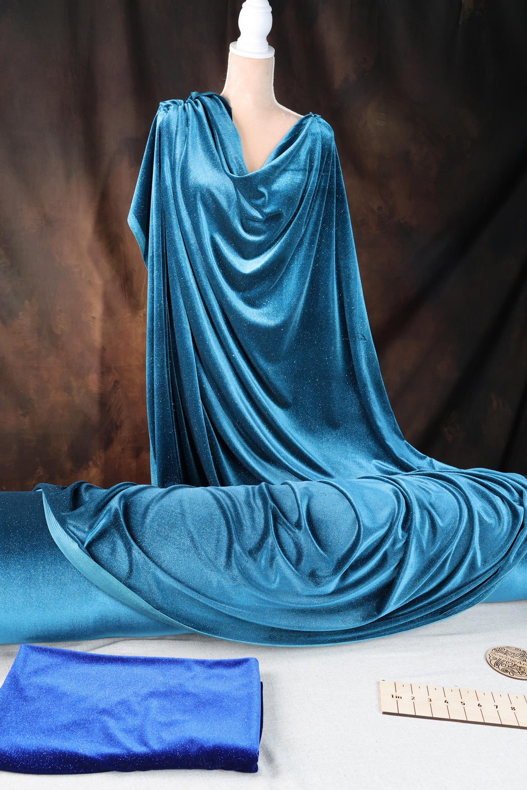 a mannequin dressed in a blue draped dress