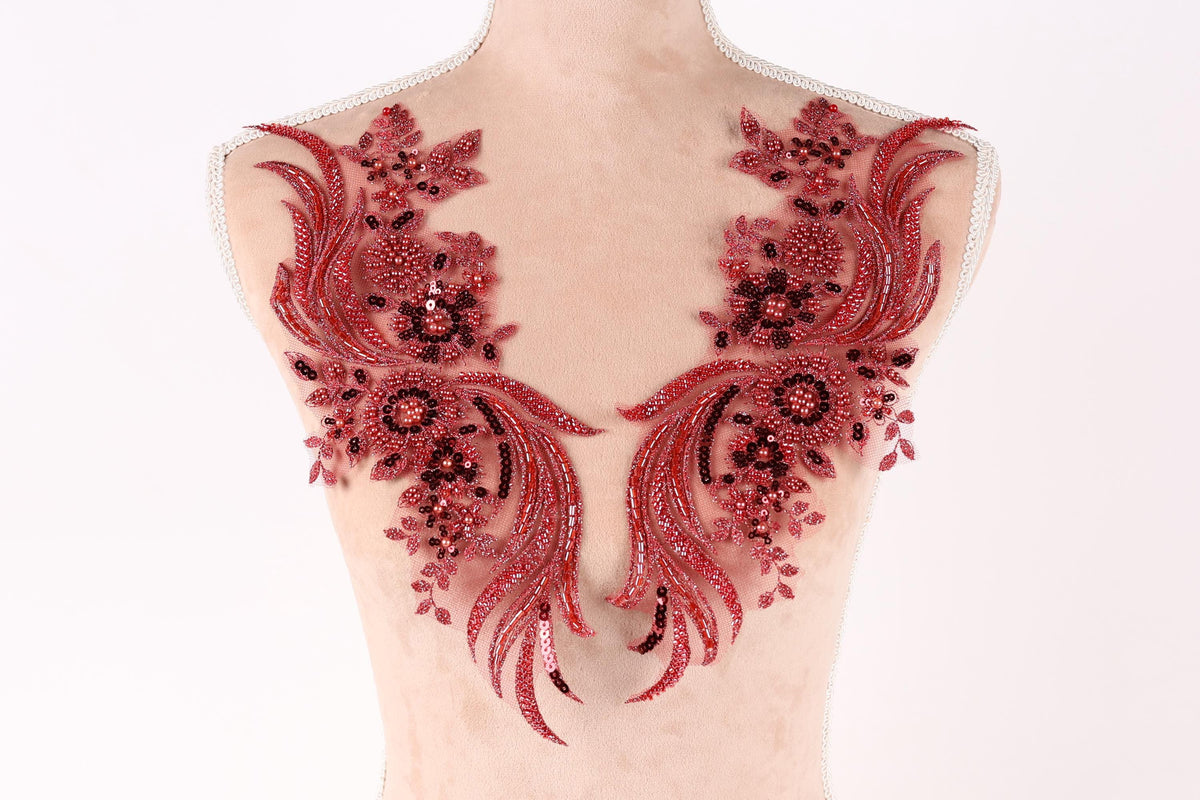 A mannequin torso with red sequin and floral embellishments on the bust area.