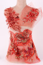 a dress with a red floral design and a butterfly motif, including red flowers and a butterfly.