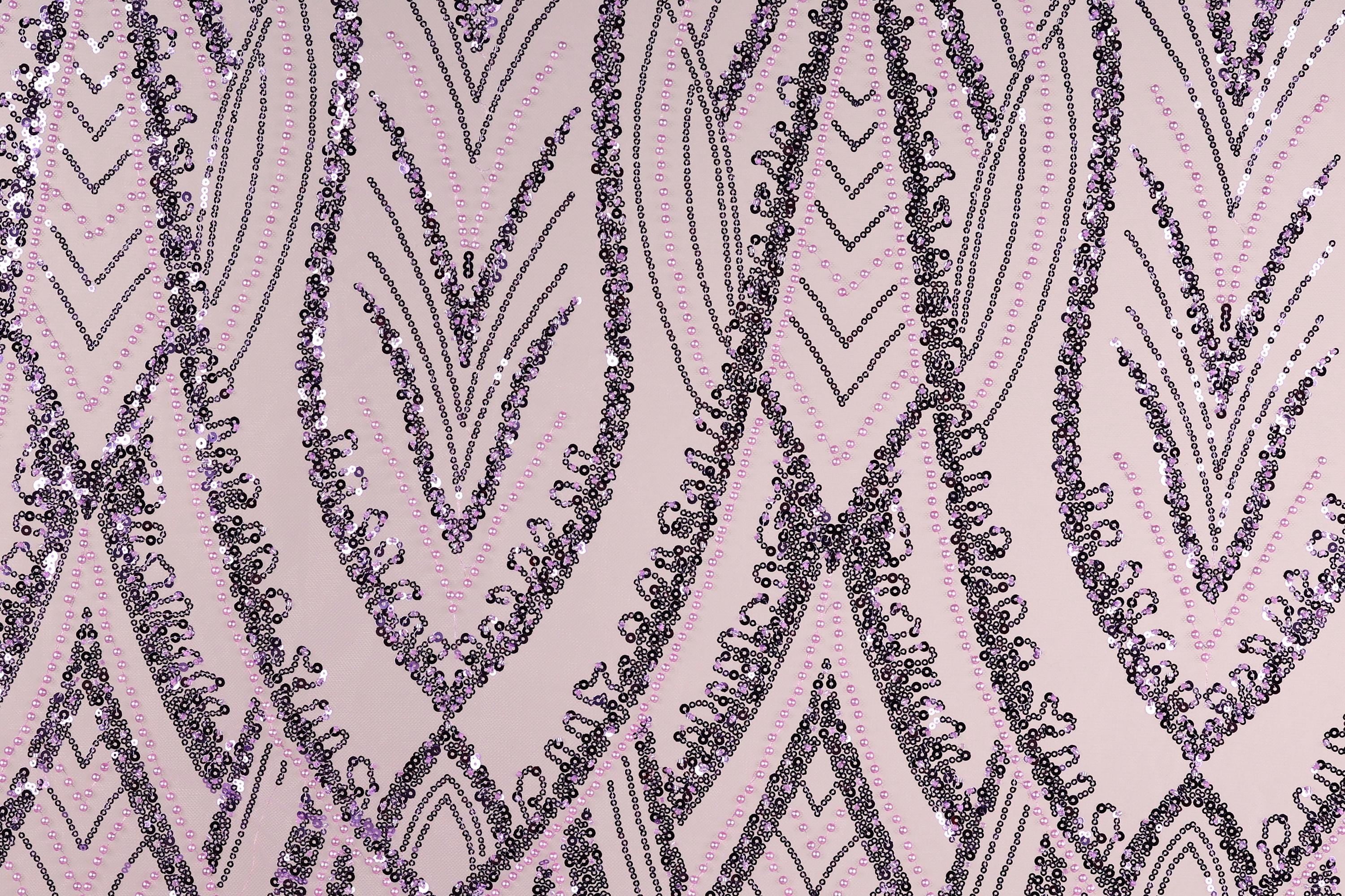 a repeating pattern of purple and black sequin designs on a light pink background.