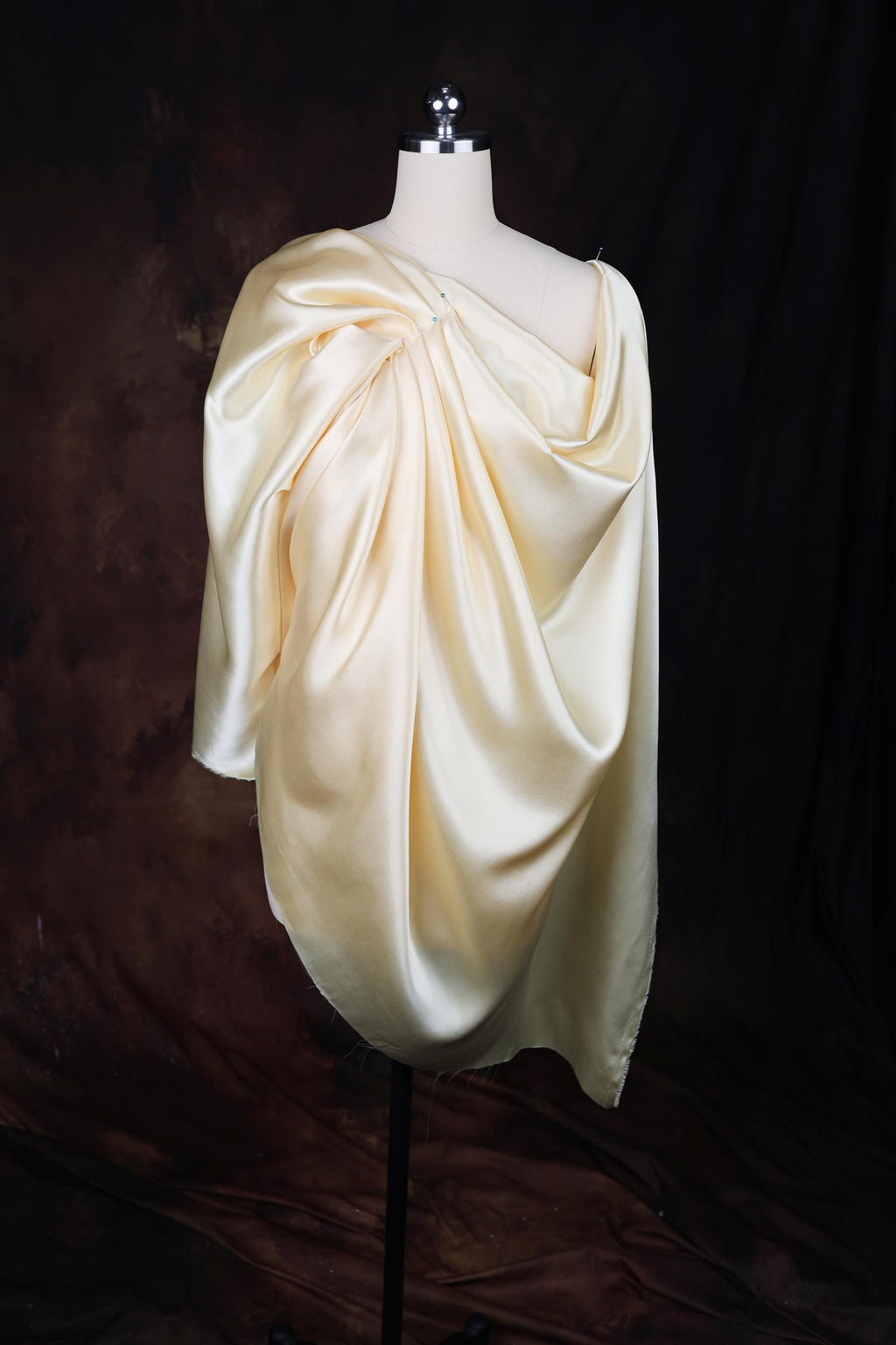 a white dress on a mannequin on a black background