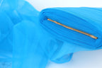 A close-up view of a blue fabric with a gold zipper, creating a visually striking contrast.