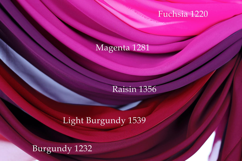 a close-up view of a collection of fabric swatches in various shades of pink, ranging from light to dark.