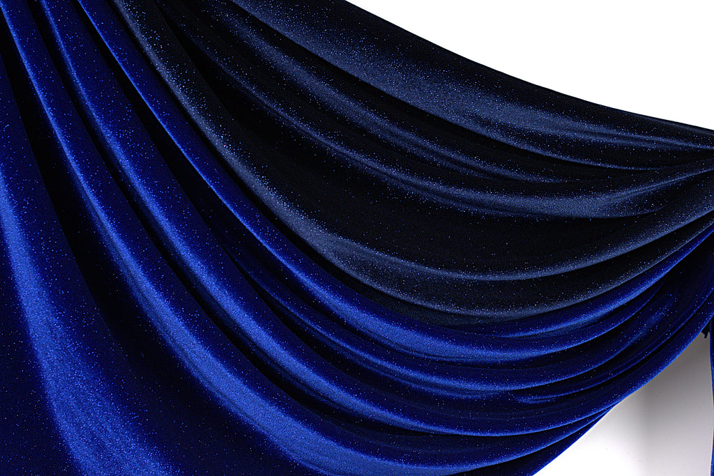 a close-up view of a shiny, blue fabric with a smooth, flowing texture. The fabric appears to be made of a shiny, satin-like material, giving it a luxurious and elegant appearance.