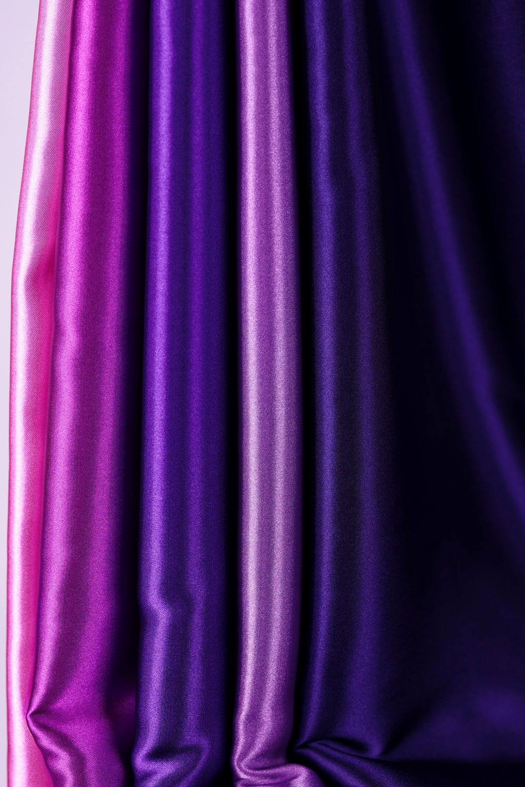 a close-up view of a collection of fabric swatches in various shades of purple and pink.