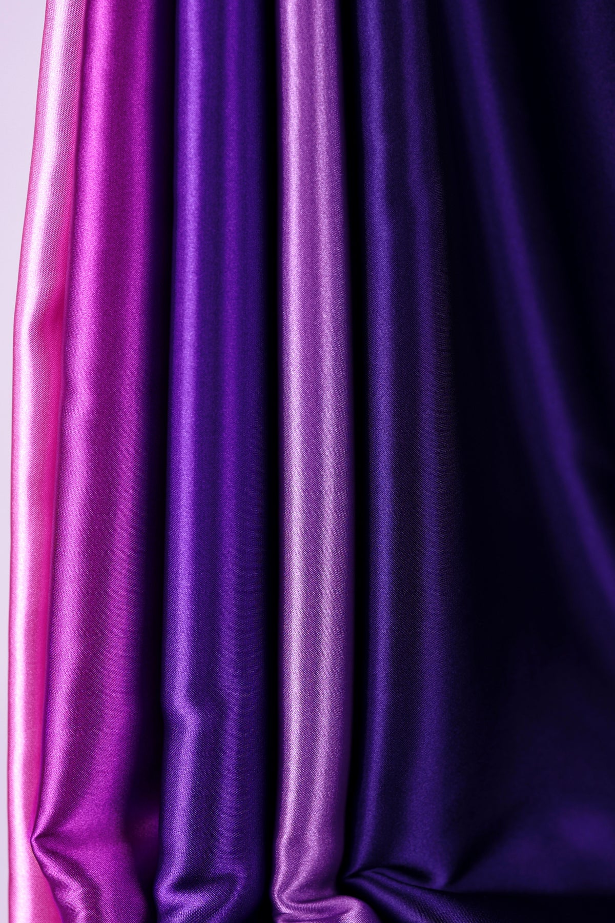 a close-up view of a collection of fabric swatches in various shades of purple and pink.