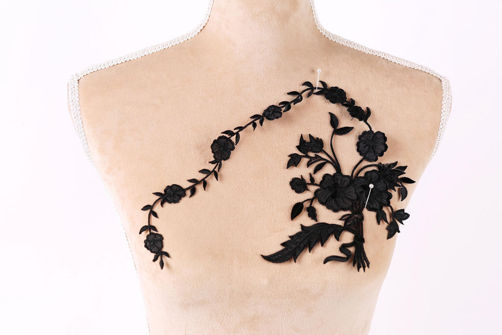 a mannequin with a black floral embroidery on its bust.