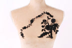 a mannequin with a black floral embroidery on its bust.