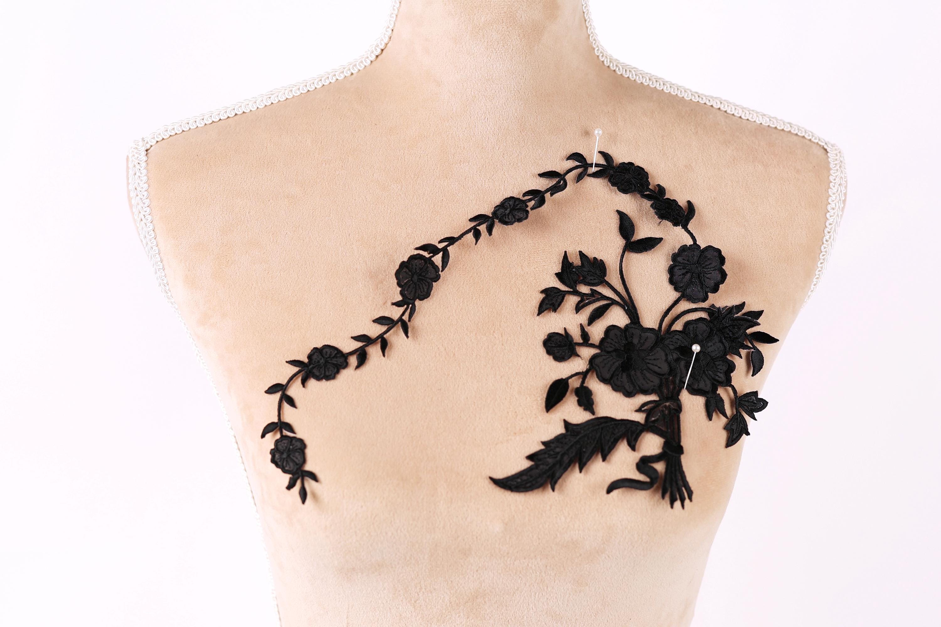 a mannequin with a black floral embroidery on its bust.