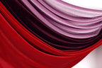 a close-up view of a fabric with a gradient of red and purple colors, creating a visually striking and vibrant pattern.