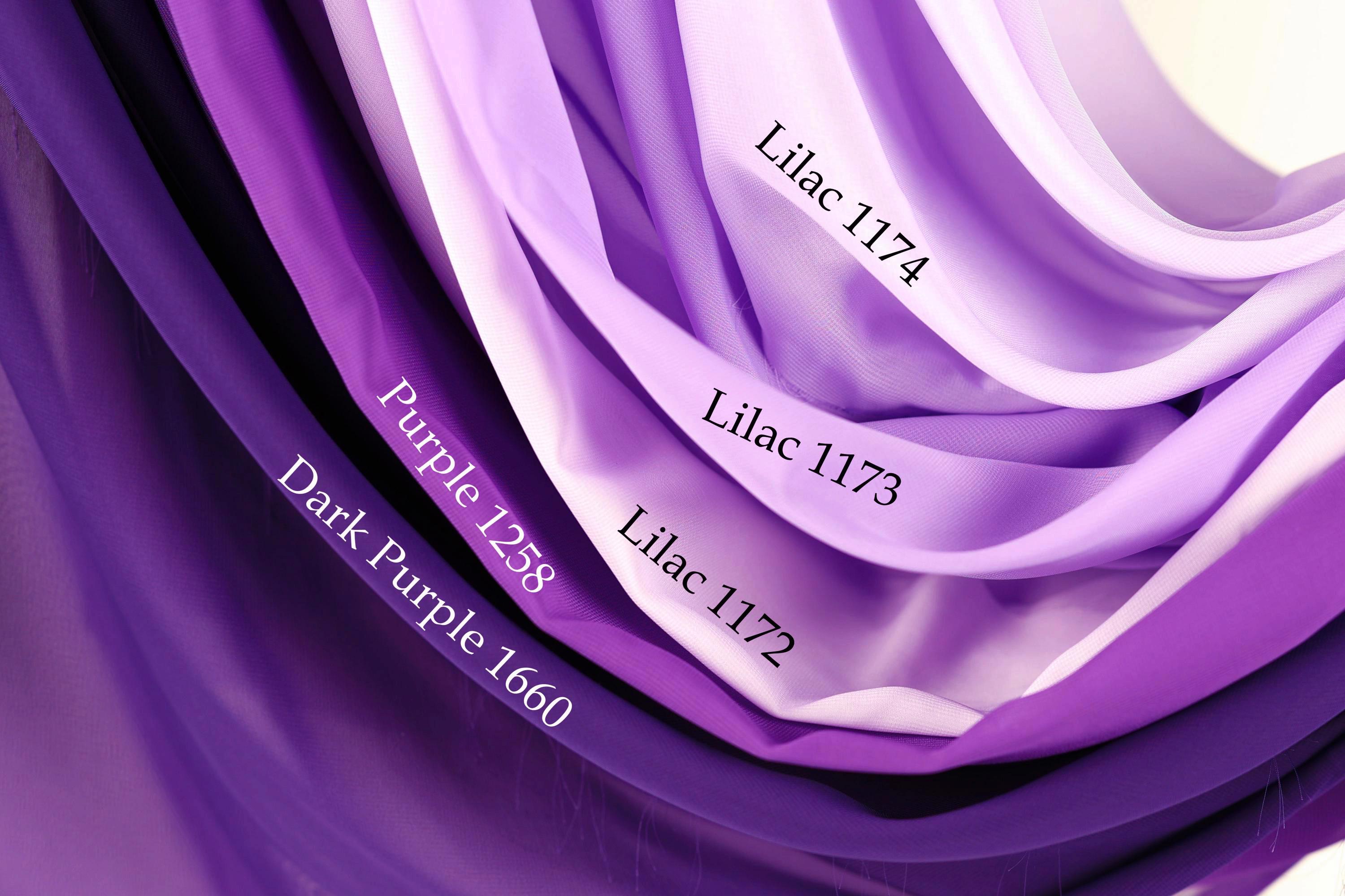 a close-up view of a fabric with different shades of purple, ranging from dark purple to lavender. The fabric appears to be a type of chiffon or sheer material, with each shade having a distinct color and texture. The image does not contain any text, and the focus is on the visual representation of the fabric's color variations.