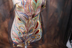 a close-up view of a decorative dress with intricate embroidery and a floral pattern.