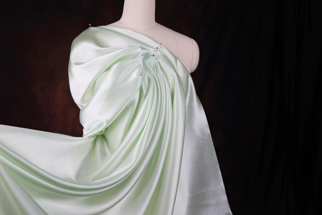a mannequin dressed in a white and green dress