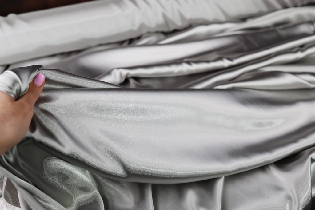 a person holding a piece of cloth in their hand