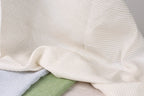 a close-up view of a fabric with horizontal stripes in various colors, including white, blue, and green.