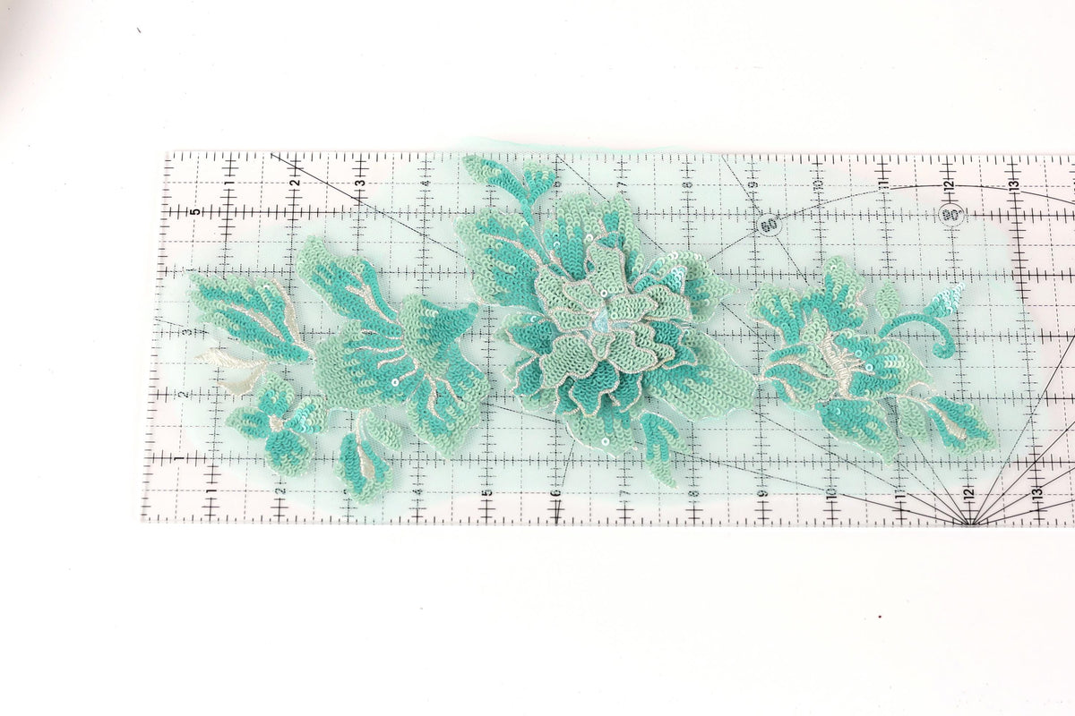 a clear ruler with a floral pattern on it, displaying various shades of green and white flowers and leaves.