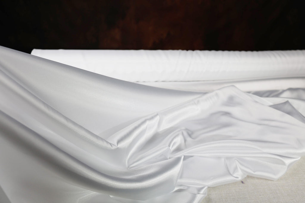 a close up of a bed with white sheets