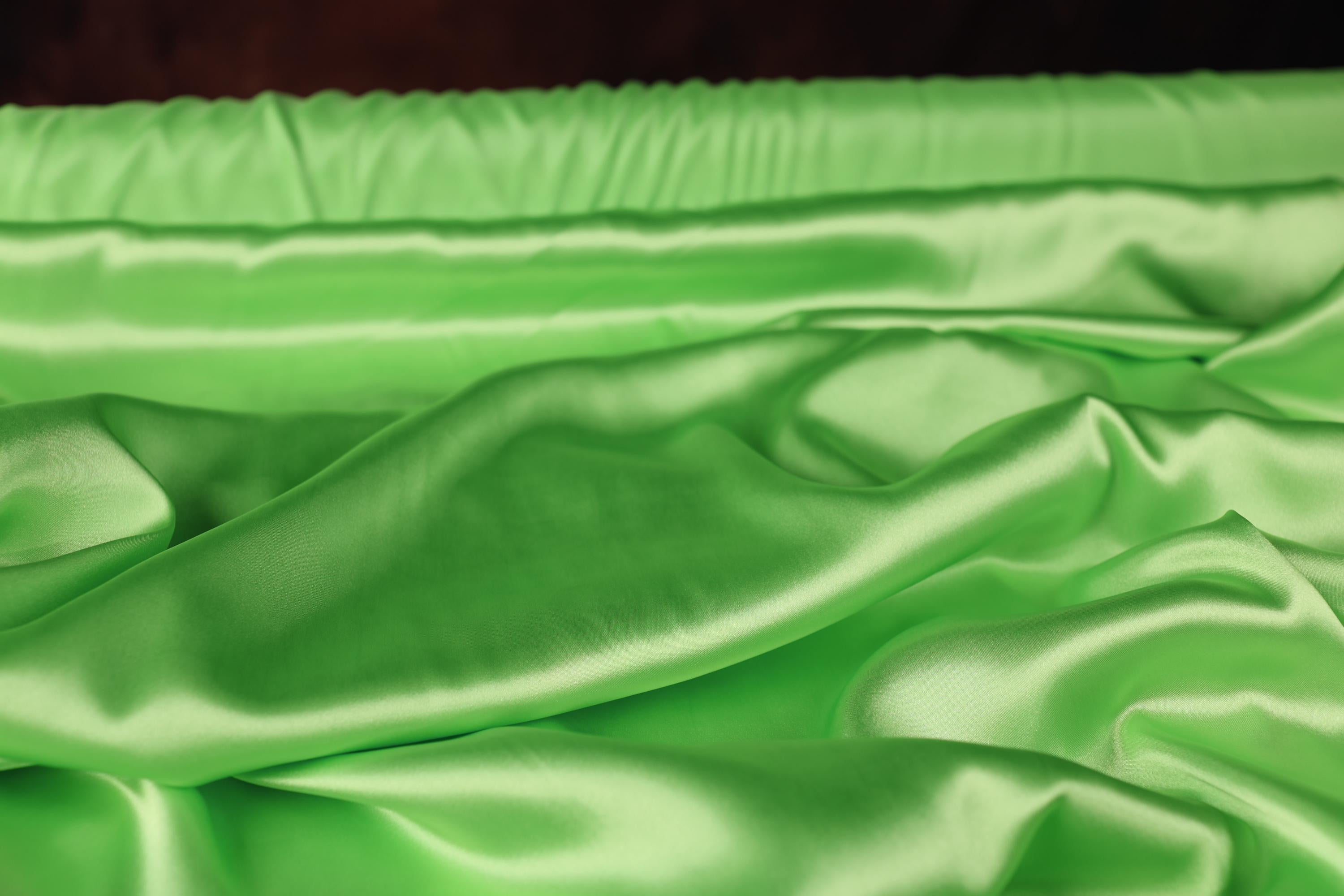 a close up of a green satin material