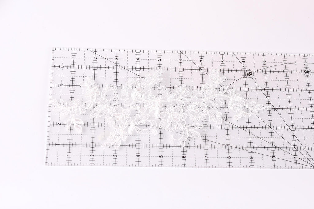 a transparent ruler with a grid pattern, placed on a white surface.