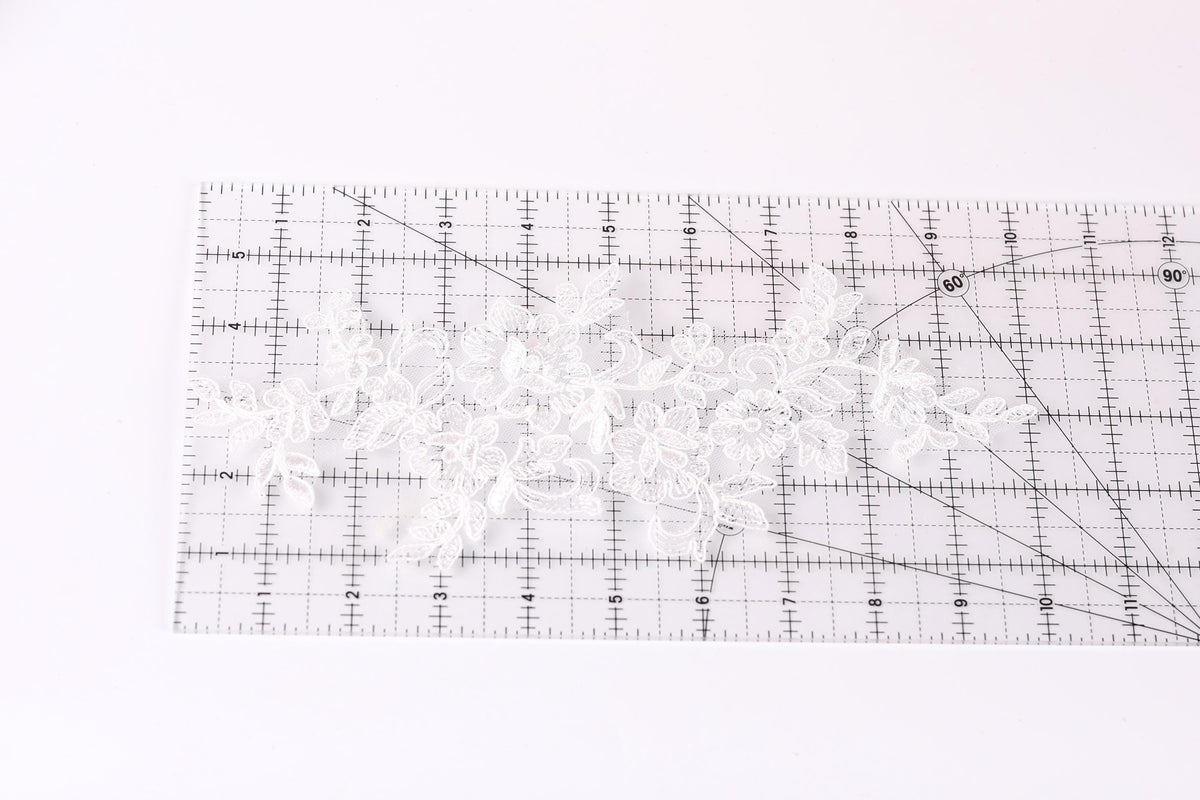 a transparent ruler with a grid pattern, placed on a white surface.