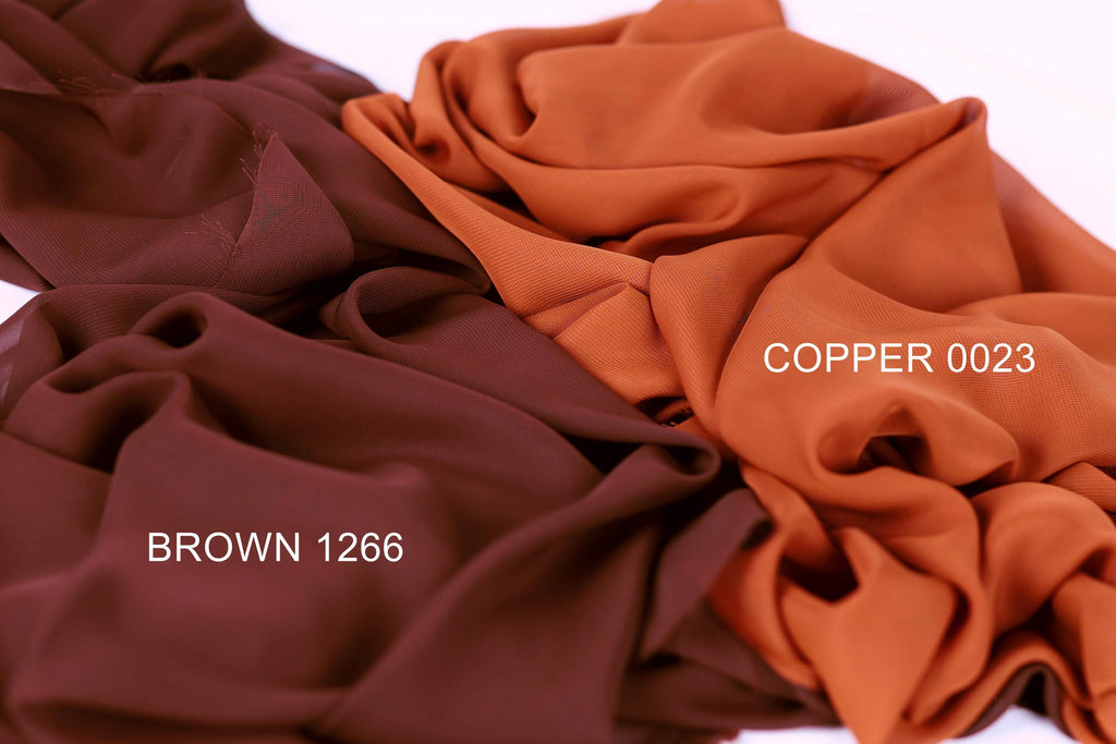 three different fabric swatches, each with a distinct color: brown, copper, and brown. The swatches are arranged in a way that allows for easy comparison and identification of the colors.
