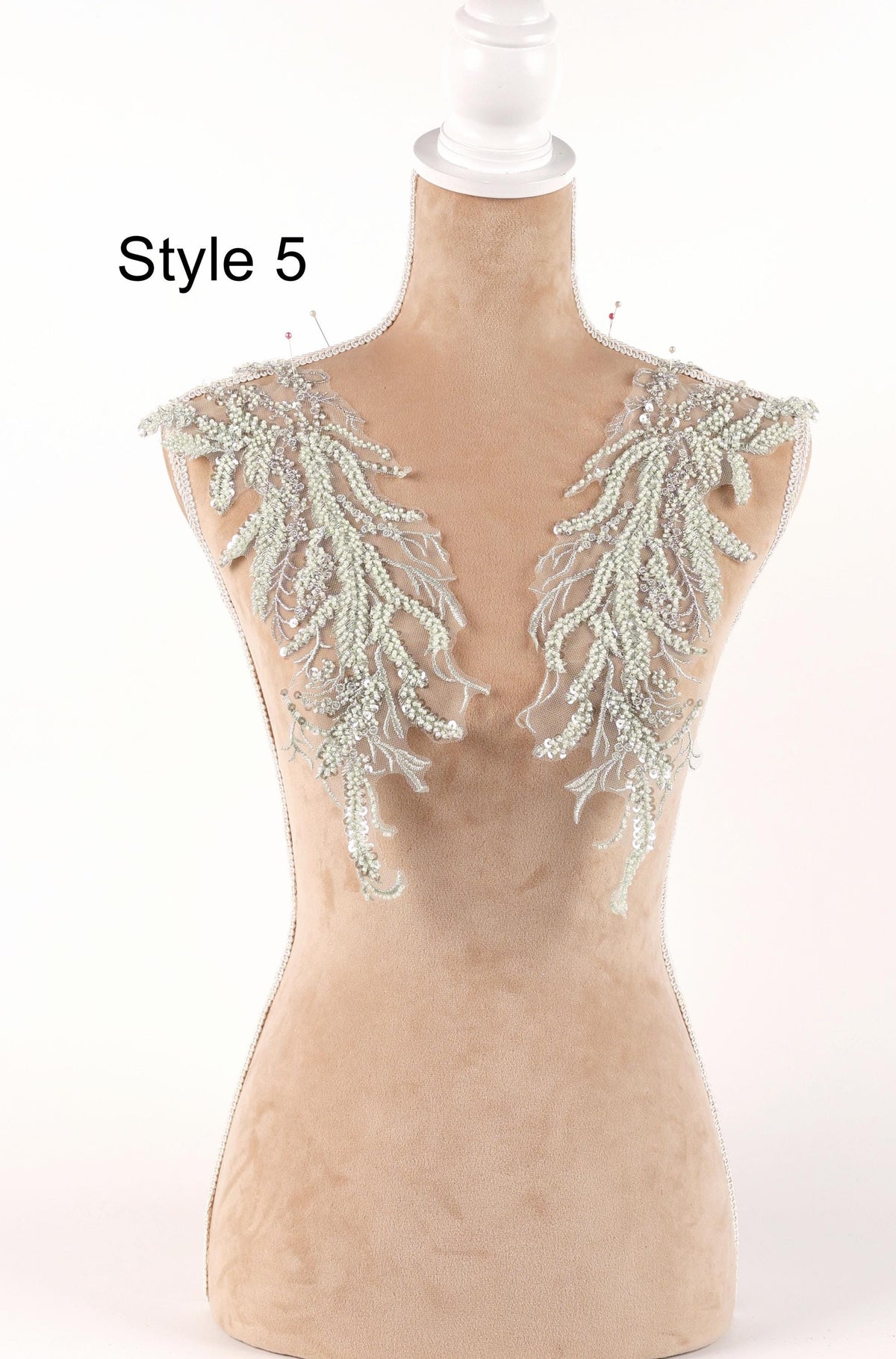 A mannequin with a beige body and white floral embellishments on its shoulders, labeled as "Style 5".