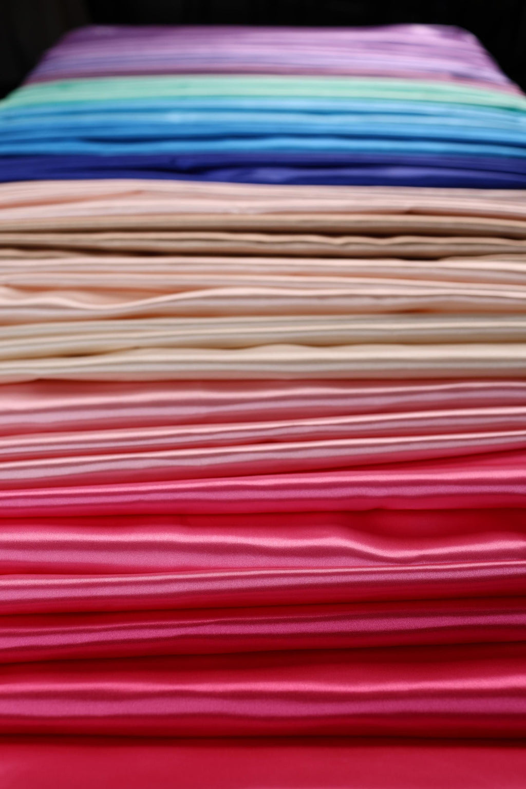 a stack of folded clothes sitting on top of each other