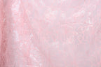 a close-up view of a delicate, pink, lace-like fabric with a floral pattern. The fabric appears to be made of sheer material, giving it a soft and delicate appearance. The floral pattern consists of various shades of pink, ranging from light to dark, creating a visually appealing and intricate design. The fabric is spread across the entire image, filling the frame and drawing the viewer's attention to its delicate texture and intricate design.