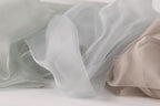 a close-up view of a soft, flowing fabric with a light blue and white color palette.