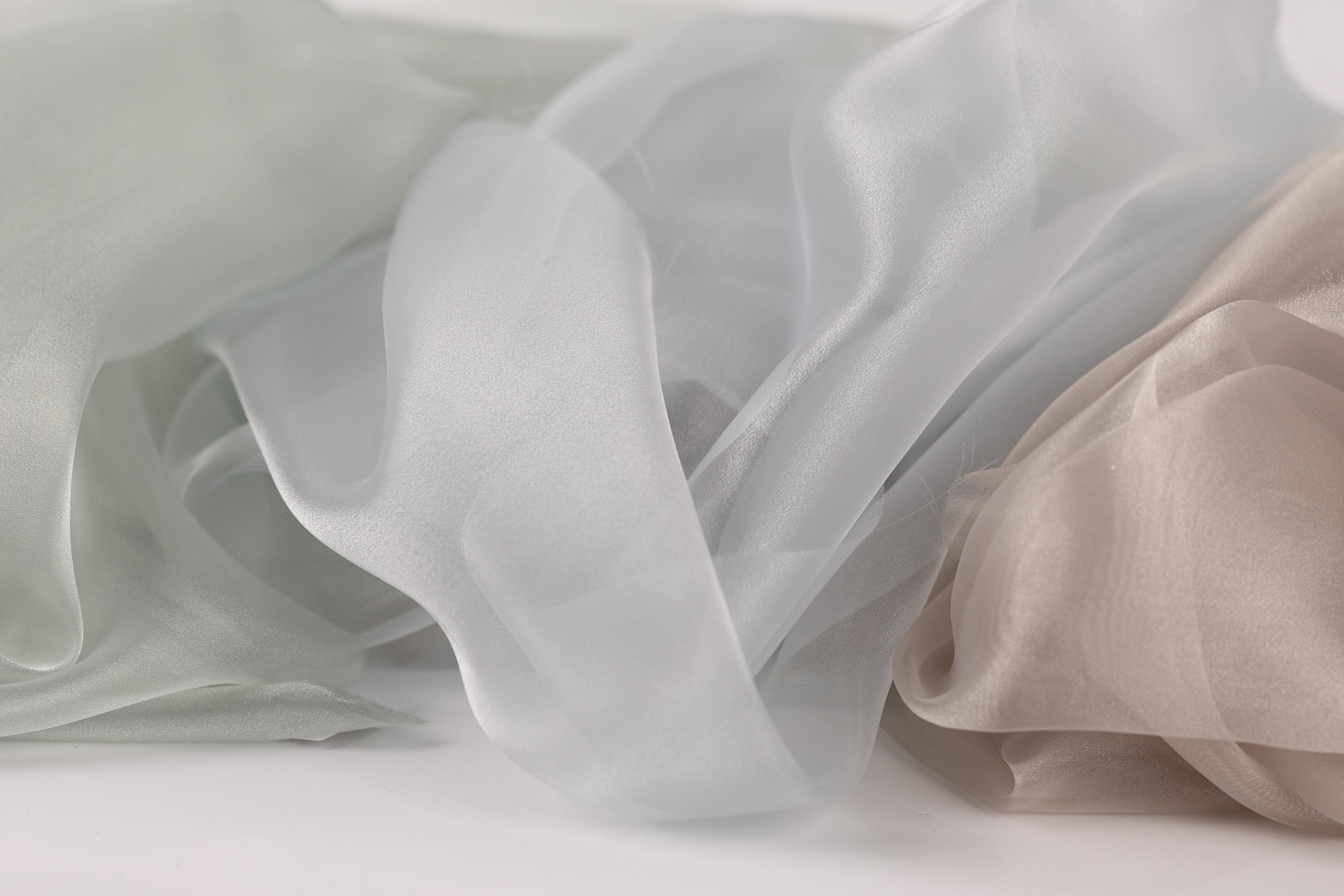 a close-up view of a soft, flowing fabric with a light blue and white color palette.