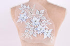 A mannequin torso with a delicate floral embroidered patch on the back.