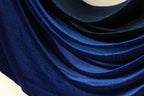 a close-up view of a fabric with a blue and black color scheme, featuring a shiny, glittery texture.