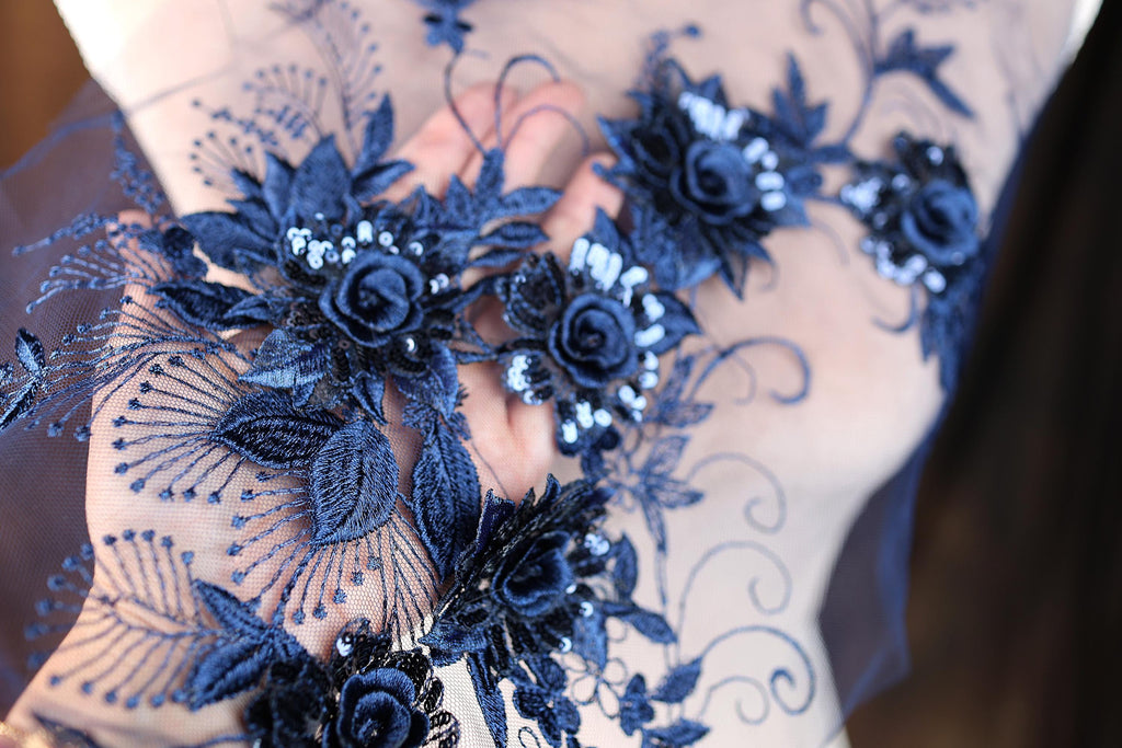 a close up of a person wearing a dress with flowers on it
