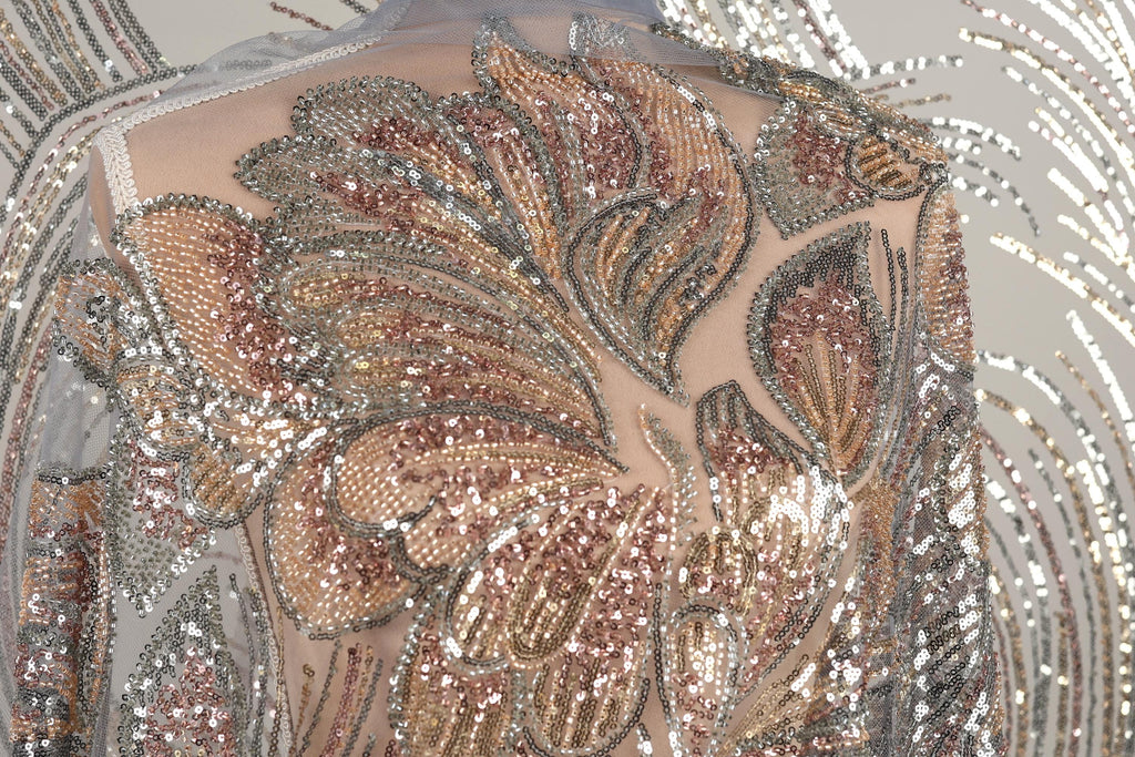 a close-up view of a sequin-covered fabric, showcasing the intricate and detailed patterns created by the sparkling beads.