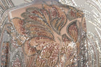 a close-up view of a sequin-covered fabric, showcasing the intricate and detailed patterns created by the sparkling beads.