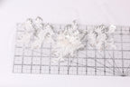 a close-up view of a transparent ruler with a floral pattern on it, placed on a white surface.