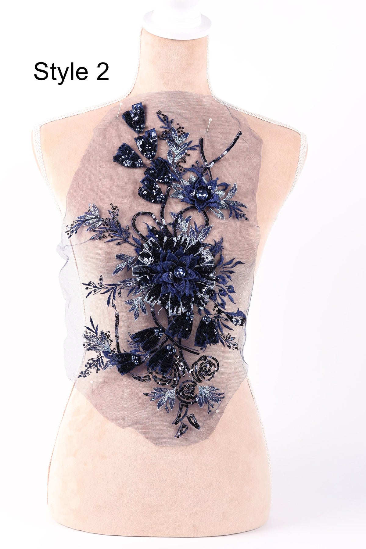 A mannequin with a floral pattern on its bust, featuring blue and white flowers and leaves.