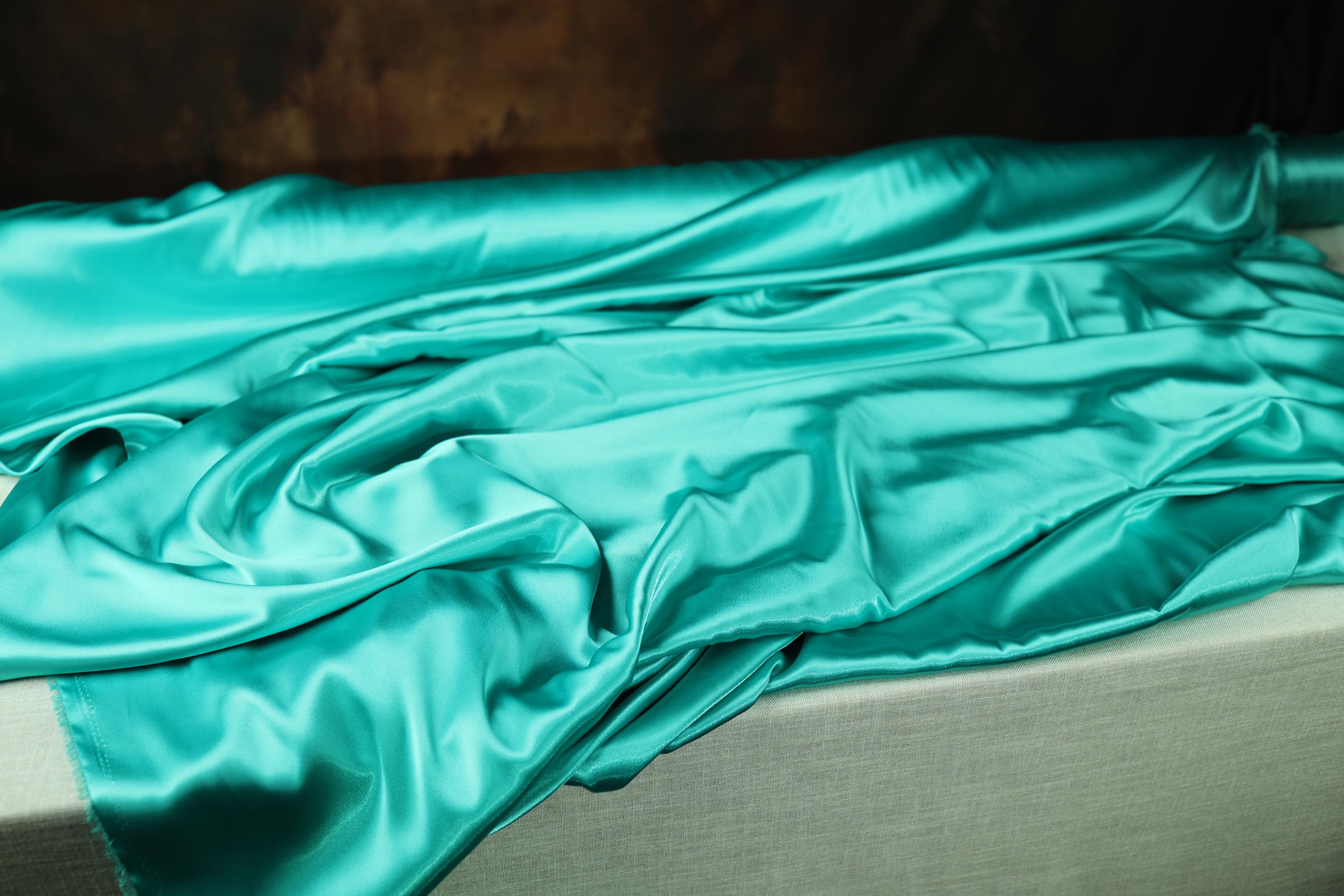 a bed with a green sheet on top of it