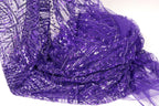 a close-up view of a piece of purple fabric with a shimmering, sequined texture.