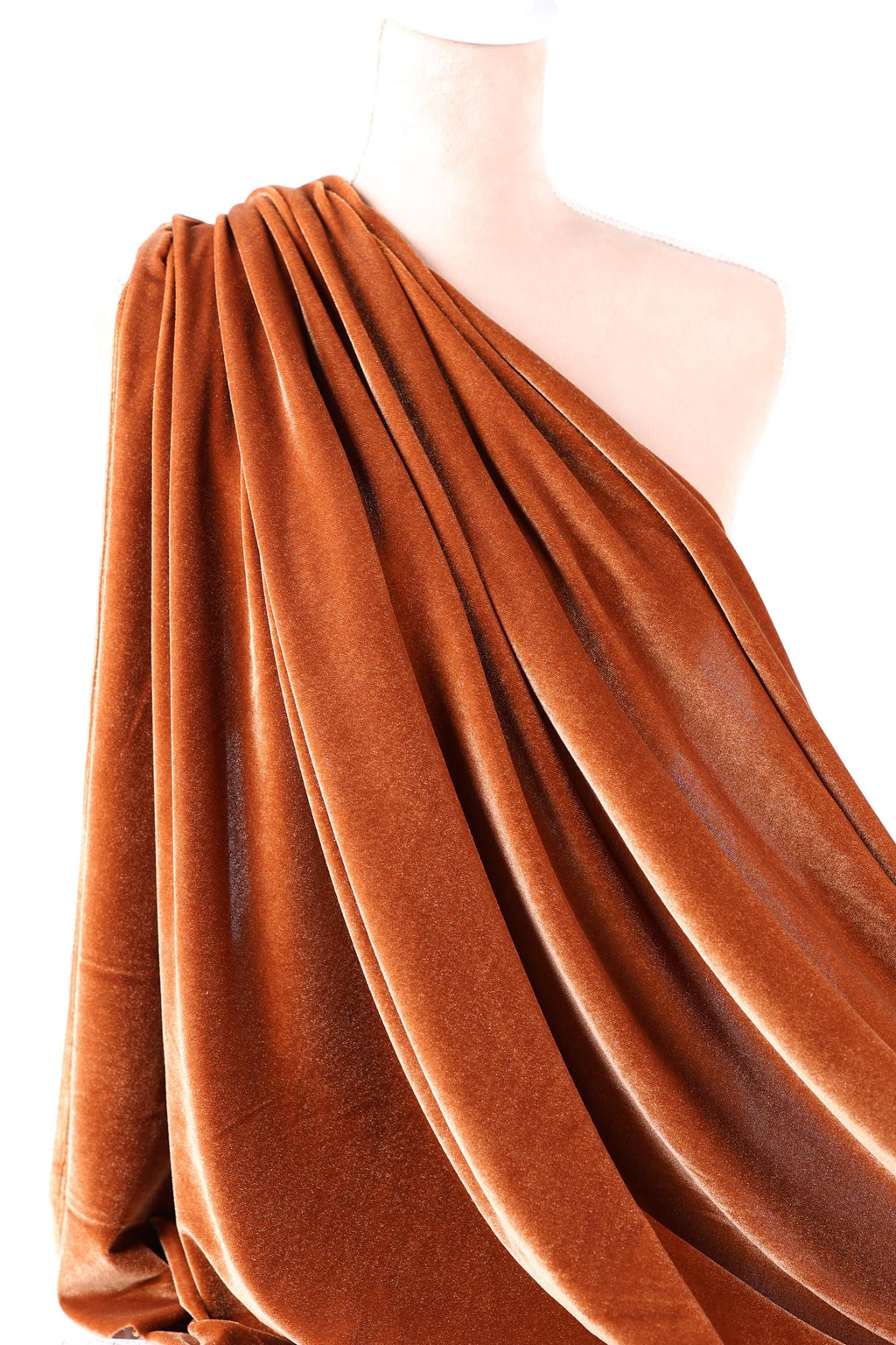 a close-up view of a piece of orange velvet fabric, with its folds and creases visible.