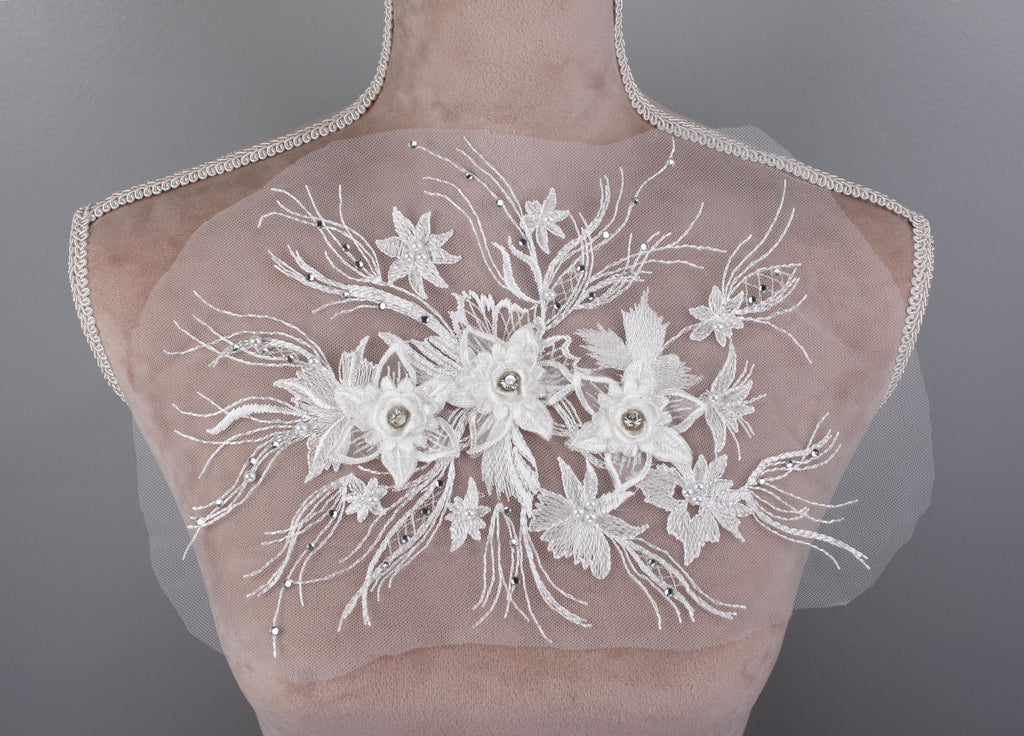 a bridal dress with flowers on the back of it